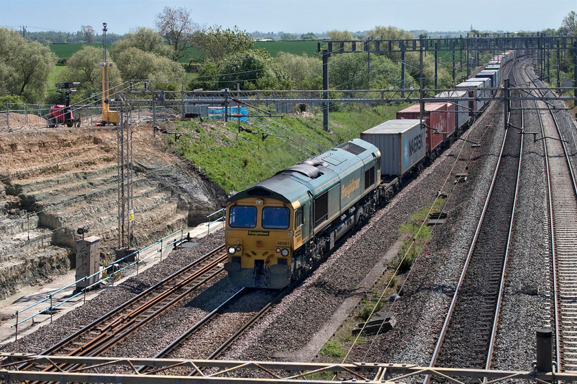 66561, 07.50 Felixstowe North-Lawley Street (4M94, 39E), Ashton Road bridge 
 Passing the currently inactive works site just south of Roade 66561 leads the 07.50 Felixstowe to Lawley Street 4M94 Freightliner service. The site has been closed since 08.04.20, coming up for a month now, due to a tragic fatality of a worker at the site. I do not know how long it takes the authorities to undertake their work and publish their interim findings but, until then, no work can take place. 
 Keywords: 66561 07.50 Felixstowe North-Lawley Street 4M94 Ashton Road bridge