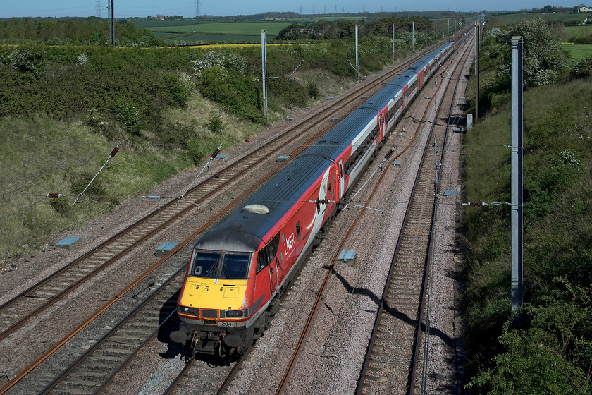 82204 & 91102, 05.48 Edinburgh-London King`s Cross (1E02, 8L), Essendine TF043129 
 DVT 82204 leads the 1E02 05.48 Edinburgh to King's Cross past Essendine at the southern end of Stoke Bank. 91102 'City of York' was providing the power to the train at the rear of the set of Mk. IV stock. Despite the elevated viewpoint atop of a farm occupation bridge, the wires still interfere with the image, a problem all too common on our electrified lines. 
 Keywords: 82204 91102 05.48 Edinburgh-London King`s Cross 1E02 Essendine TF043129