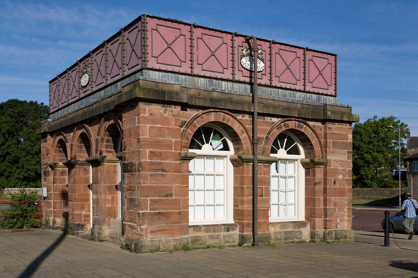 Former water tower, Haltwhistle 
 Andy walks around and inspects the former water tower at Haltwhistle station now located in between the station car park and the up platform. According to Historic England the building dating from 1861 was designed by Peter Tate and built by R. Wylie and Co. for the North Eastern Railway Company. It has an Iron water tank on a stone base (red ashlar sandstone on front and right returns; dressed sandstone on rear and left return). Cast iron water columns. It is Grade II listed so its future is assured but there is currently a local debate as to how it should be used in the future; watch this space! 
 Keywords: water tower Haltwhistle