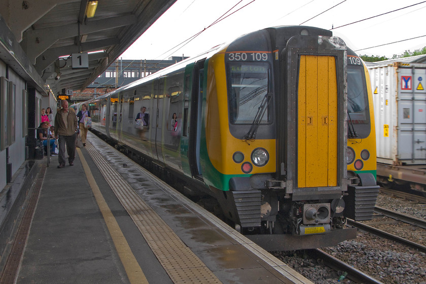 350109, LM 06.49 Crewe-London Euston (2Y00), Northampton station 
 As a Freightliner passes on the adjacent centre road, London Midland's 350109 waits to leave Northampton with the 06.49 Crewe to Euston service. Despite the recent work to re-build Northampton's station building, platform one remains a narrow and dingey place to wait for a train to London. 
 Keywords: 350109 06.49 Crewe-London Euston 2Y00 Northampton station London Midland Desiro