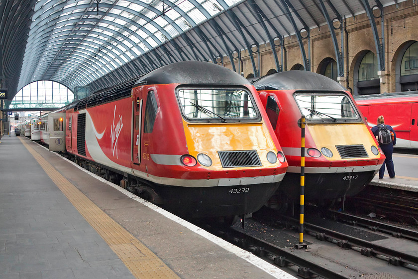 43239, GR 12.00 London King`s Cross-Inverness (1S16, 1E) & 43 317, 10.55 Bounds Green-London King`s Cross ECS (3S16), London King`s Cross station 
 Two HSTs on the blocks at London King's Cross. 43239 is about to leave at the back of the 1S16, 'The Highland Chieftain', the 12.00 to Inverness. 43317 has just arrived with the 3S16 ECS working from Bounds Green. Both these power cars have had very different histories. 43239 was delivered to the Western Region in 1977 as 43039 and formed part of 253019. Whereas, 43317 has always been an Eastern Region power car being delivered new in 1979 and forming part of set 254032. 
 Keywords: 43239 1S16 43317 ECS 3S16 London King's Cross station