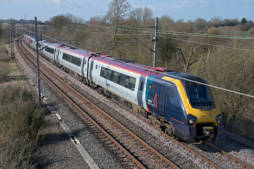 221114 & 221107, 08.52 Edinburgh Waverley-London Euston (9M52, 2E), Bugbrooke footbridge 
 221114 is seen wearing its Avanti West Coast revised front end livery but this cannot hide its former operator's identity! Along with 221107 the pair of Voyagers pass Bugbrooke in Northamptonshire working the 9M52 08.52 Edinburgh to Euston service. This was as low as I could get to take this photograph that involved me lying on the floor of the bridge but even this unorthodox position could not eradicate the return wire spoiling the image. 
 Keywords: 221114 221107 08.52 Edinburgh Waverley-London Euston 9M52 Bugbrooke footbridge Avanti West Coast Voyager