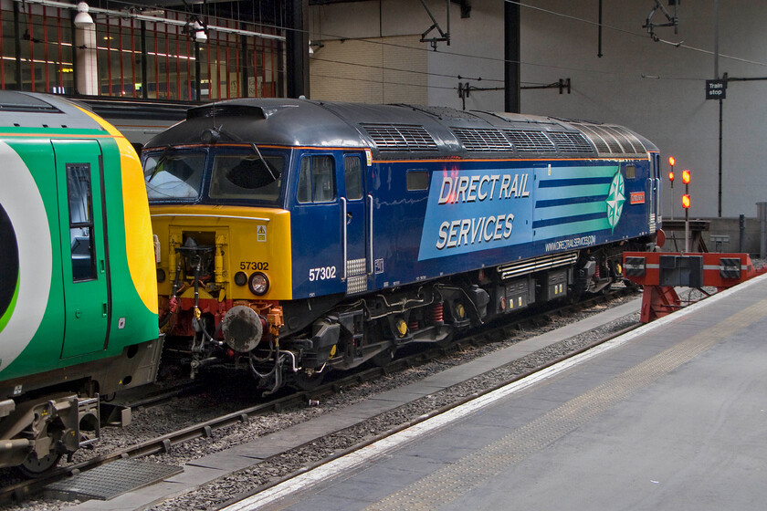 57302, stabled Thunderbird, London Euston station 
 57302 'Chad Varah' sits on the stops at London Euston acting as a stabled Thunderbird for Virgin Trains. Back in the 1970s this was one of my most recorded Class 47s being one of Western Region's 'namers'. Then it was numbered 47081 and named 'Odin'. So far, I have not managed to upload any images from that time on to my website but there are plenty more images to come! 
 Keywords: Chad Varah 57302 stabled Thunderbird London Euston station