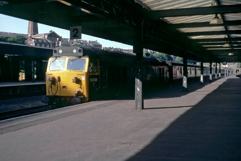 50025, 15.10 London Waterloo-Exeter St. David's, Exeter Central Station 
 Exeter Central's station clock reveals that it is 19.35 as 50025 'Invincible' arrives at the station leading the 15.10 Waterloo to Exeter St. David's. This picture would have been more photographically 'correct' had I been standing on platform one at this time in the evening, but I actually like the effects created by the shadows of the train and the station structures. The large Victorian building in the background is HMP Exeter which is still in use today, being the principal prison for offenders in the West Country. 
 Keywords: 50025 15.10 London Waterloo-Exeter St. David's Exeter Central Station Invincible