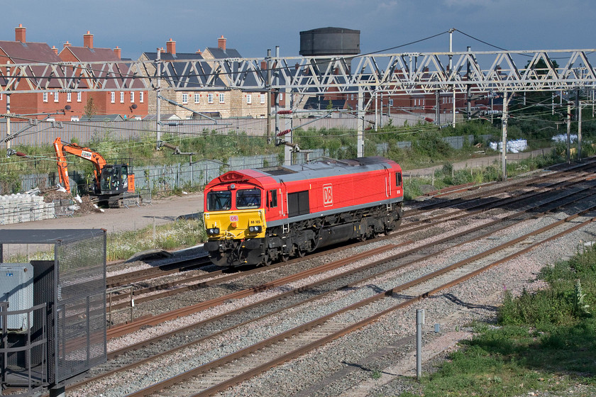 66105, 17.21 Wembley yard-Arpley (0Z42, 32E), site of Roade station 
 This is my first photograph of 66105 since its repainting into DB red. Under a threatening and stormy black sky that did indeed deliver some rain in the next hour or so, it passes the site of Roade's former station as the 17.21 Wembley to Arpley (Warrington) light engine move. 
 Keywords: 66105 17.21 Wembley yard-Arpley site of Roade station 0Z42 Light engine DB