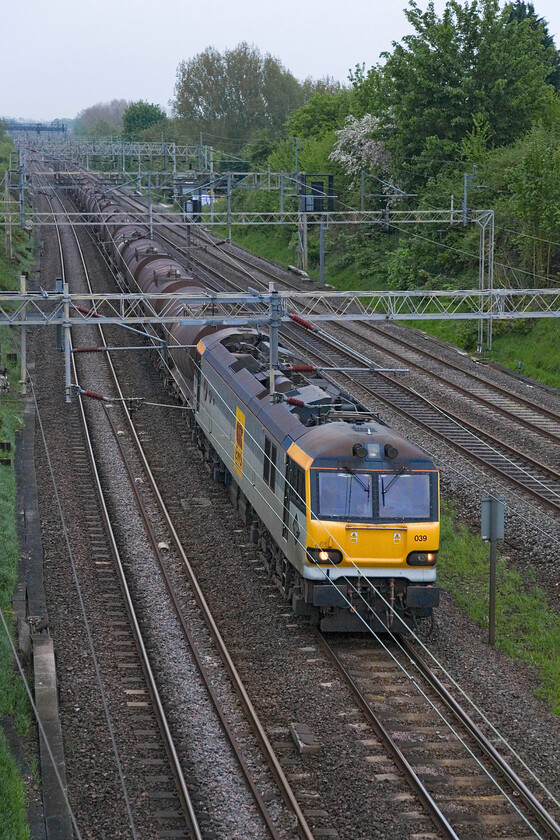 92039, 03.06 Dollands Moor-Irvine (6S94), Victoria bridge 
 This is a train that passes along the southern section of the WCML most weekdays but it is one that I have very few photographs of as it usually passes in the dark. However, today it is running some ninety minutes late so a photograph can be captured. 90039 'Johann Strauss' leads the 6S94 03.06 Dollands Moor to Irvine china clay slurry train. This is a very heavy train often weighing in towards two thousand tonnes meaning that only the power of a Class 92 is able to haul it over the torturous gradients of Cumbria. If one is unavailable, it has to be a pair of Class 66s, but this is not common. The train is seen approaching Roade from Victoria bridge. 
 Keywords: 92039 03.06 Dollands Moor-Irvine 4S94 Victoria bridge china clay slurry Johann Straus