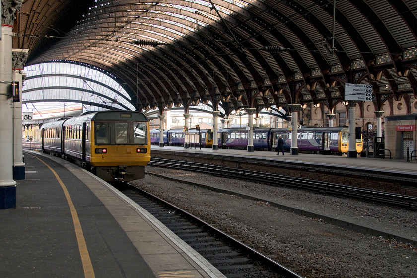 142012, NT 08.50 Doncaster-York ECS (5Y90), class 142 & 142091, stabled, York station 
 Pacers have been a common sight at York for thirty years now. By the end of next month, they should be a thing of the past but due to the late arrival of their replacements, I suspect that they will be around for a bit longer yet. To the left, 142012 has just arrived with the 08.50 Doncaster to York ECS working. Meanwhile, over in the bay stabling platform two further units are seen between services. The one nearest the camera is 142091, a unit that I have photographed at York many times. 
 Keywords: 142012 08.50 Doncaster-York ECS 5Y90 class 142 142091 stabled York station pacer