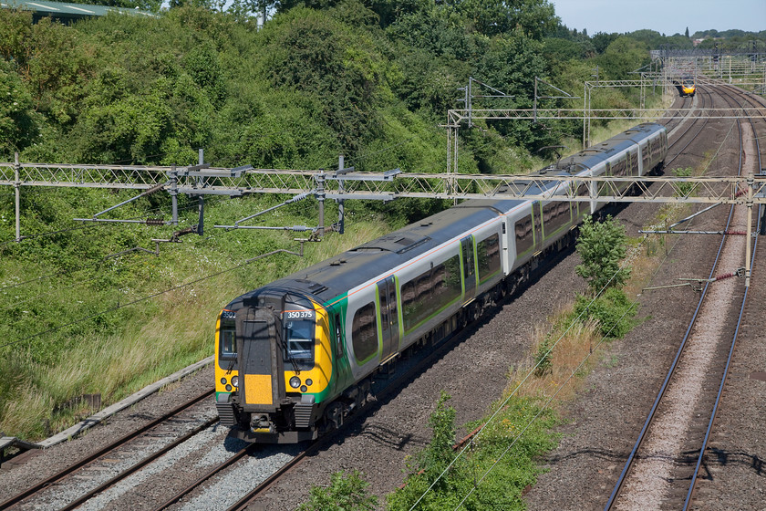 1. 350375, LN 09.02 Crewe-London Euston (1U24, 2L), Victoria Bridge 
 London Northwestern 350375 heads on the up fast past Victoria Bridge working the 09.02 Crewe to London Euston. A class 390 can just be seen on the down fast heading towards Roade, just in the background. 
 Keywords: 350375 1U24 Victoria Bridge