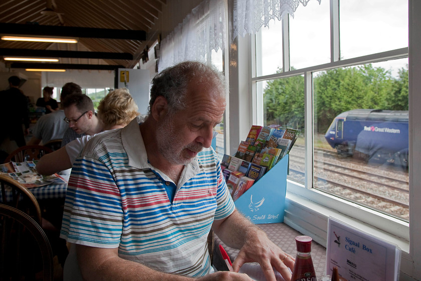 Andy, 43170, GW 09.06 London Paddington-Penzance (1C76, 9L), Signal Box Cafe, Totnes station 
 Andy collecting the coach numbers from the 09.06 Paddington to Penzance as it arrives at Totnes station with 43170 is at the rear of the train. 43170 was a late delivery as part of the penultimate batch introduced to the NE/SW route in 1982 as part of set 253044. We are sitting in Totnes' former signal box that is now the home to two cafs, one on the ground floor that once housed the frame and this one on the first floor. Both appeared to be very popular with both passengers and locals. I photographed the exterior of the box on a dark night back in August 1980, see.... https://www.ontheupfast.com/p/21936chg/29740305404/totnes-signal-box-gwr-great-western 
 Keywords: Andy 43170 1C76 Signal Box Cafe Totnes station