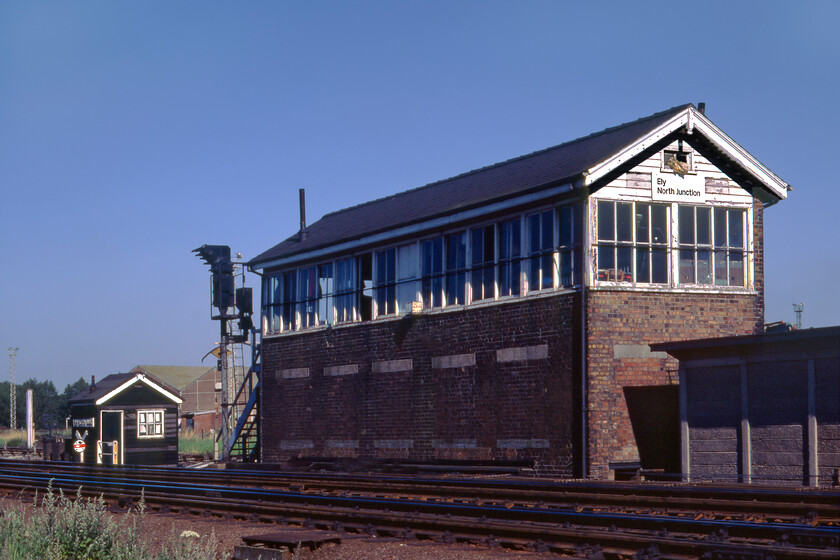 Ely North Junction signal box (LNER, 1926) 
 Ely North Junction signal box was a tricky one to get to necessitating driving on a track near the old gravel pits, parking up and walking for some distance. On arrival at the box, we then had to scramble up a bank through the undergrowth and commit a small trespass to get this photograph. The box was built in 1926 by the LNER and it was an example of their Type 11a design. It was the busiest box in the Ely area that necessitated a box lad to be rostered on day shifts. The box closed in the spring of 1992 when the signalling around Ely was modernised. Incidentally, when reversing Grahams Austin 1100 after getting this photograph, I managed to back it into a post bending the chrome bumper and boot lid bringing an end to my learner driver experience; I remember being very upset at the time. 
 Keywords: Ely North Junction signal box LNER London North Eastern Railway