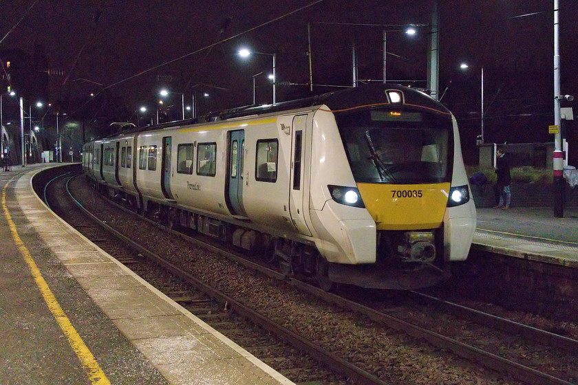 700035, TL 17.28 Rainham-Luton (9P52, RT), Kentish Town station 
 The ability of modern cameras to take images in extremely low light is astonishing. In this view at Kentish Town station 700035, working the 17.28 Rainham to Luton service, is still arriving at some speed but the camera has managed to capture the scene relatively well with no blur and, with a little work from Photoshop's NeatImage add-on, there is very little digital noise. Back on a cold night in November 1979 when I took time exposures on the same station I required a sturdy tripod and an exposure of some twenty seconds to get a reasonable image on a Kodachrome 64 slide. However, there is something about the 'quality' of images taken using that fine film media that cannot be quite replicated on modern equipment but I am not absolutely sure what that elixir is? 
 Keywords: 700035 17.28 Rainham-Luton 9P52 Kentish Town station Thameslink