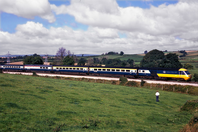 Class 43 & GGV, 09.45 Plymouth-London Paddington (1A16), Lillisford Farm SX823647 
 The 09.45 Plymouth to Paddington HST service passes our campsite at Lillisford farm between Totnes and Newton Abbot. This 1A16 was the first up express service on a Sunday morning and Graham looks suitably unimpressed that it was an HST looking as though he has not raised his camera to capture the scene. Unfortunately, due to some motion blur, I have been unable to identify the power car leading the train 
 Keywords: Class 43 HST 09.45 Plymouth-London Paddington 1A16 Lillisford Farm SX823647