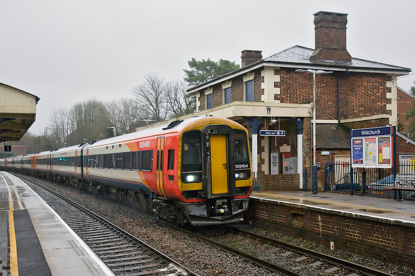 159104, 12.20 London Waterloo-Bristol Temple Meads (1V33), Whitchurch station 
 159104 leads another member of the class at speed through Whitchurch (Hampshire) station. The train is running as the 1V33 12.20 Waterloo to Bristol Temple Meads SWT service. The train will split at Salisbury with one set working through to Bristol. The leading set is one of the former TransPennine Express Class 158s that was converted to a 159 about ten years ago. It's a little known fact that despite having the same engines as their Class 159/0 cousins that the 159/1 are slightly less powerful having 350bhp compared to 400bhp. I deliberately chose to position the train slightly early so as to include the attractive former London and South Western Railway station building that unfortunately is disused with its windows boarded up. 
 Keywords: 159104 12.20 London Waterloo-Bristol Temple Meads 1V33 Whitchurch station SWT South West Trains