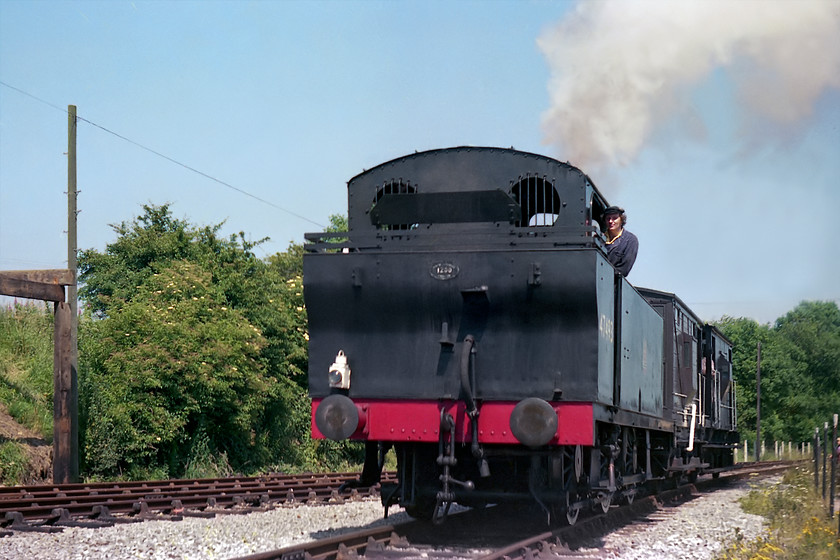 47493, brake-van working, East Somerset Railway, Cranmore 
 Ex LMS 0-6-0 46493 leads a short brake-van train near Cranmore on the East Somerset Railway. I am not absolutely sure, but the driver leaning out of the cab of the Fowler 3F looks to be the late David Shepherd. He was one of the founders of the ESR and spent a lot of his time there as well as having his own locomotive 92203 'Black Prince' based there for a while. 
 Keywords: 47493 brake-van working East Somerset Railway Cranmore