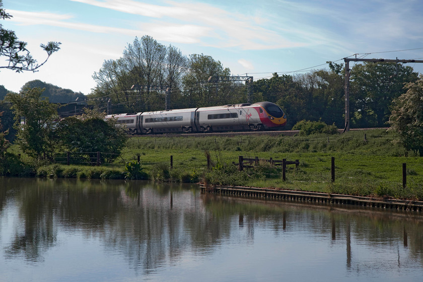 390137, VT 07.20 London Euston-Manchester Piccadilly (1H09, 1E), Bugbrooke SP679564 
 As the sun began to come round more from the south pictures from this angle began to soften a bit. Here, 390137 'Virgin Difference' forms the 07.20 Euston to Manchester 1H09 working. The train is seen side-by-side with the Grand Union Canal near the village of Bugbrooke in Northamptonshire. 
 Keywords: 390137 1H09 Bugbrooke SP679564