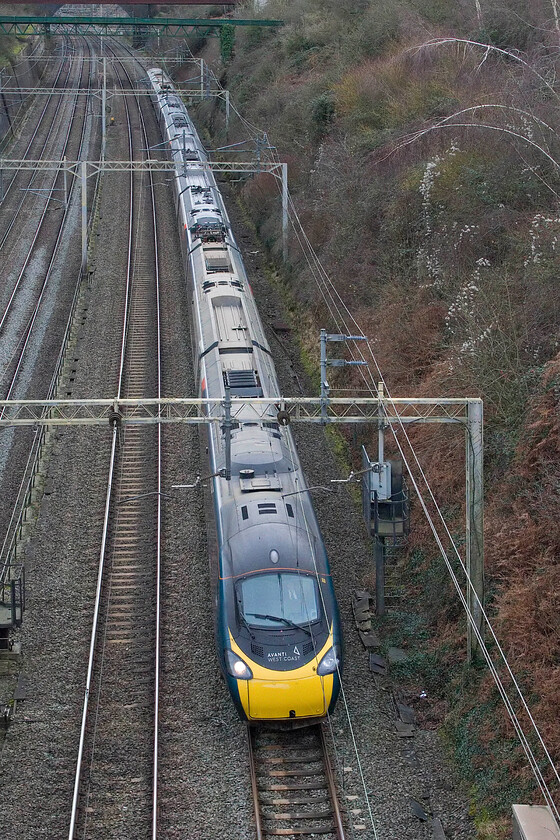 390020, VT 12.42 London Euston-Liverpool Lime Street (1F22, RT), Roade cutting 
 With a firm toot from the driver, the 12.42 Euston to Liverpool Avanti service passes through Roade cutting worked by 390020. To take this photograph I am standing on locally named Accommodation bridge (Bridge 210 from London) looking south through the cutting. 
 Keywords: 390020 12.42 London Euston-Liverpool Lime Street 1F22 Roade cutting AWC Pendolino Avanti West Coast