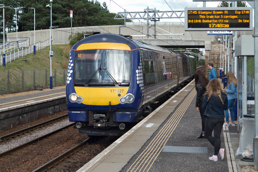 170427, SR 17.17 Falkirk Grahamston-Glasgow Queen Street (2J75, 1L), Stepps station 
 Stepps station opened in 1844 as Stepps Road. It survived until 1962 when British Railways closed it. However, after a deal was struck between BR and the Strathclyde Passenger Transport Executive it was reopened as Stepps in May 1989. It is now an important transport hub for the area with a significant number of passengers using at, largely commuters. Here, 170427 arrives into the station working the 2J75 17.17 Falkirk Grahamstown to Glasgow Queen Street that Andy and I took to its destination. 
 Keywords: 170427 2J75 Stepps station