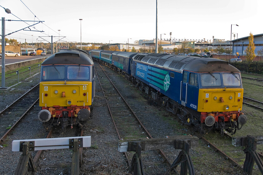 47828, 47805 & 37604, stabled, Norwich yard 
 Another view of 47828 and 47805 'Peter Bath MBE 1927-2006' stabled with their DRS stock in Norwich Yard but also included is 37604 over by the service platform. Over to the right beyond the vast Carrow Road retail park is the ground of Norwich City. Unfortunately for Canaries' supporters, they were relegated at the end of the last season finishing eighteenth in the table. Now with Mark Robson and former player Gary Holt as first team coaches, they have had a reasonable start to their season in the Championship and must be among the favourites to be promoted again?

NB They did get promoted back to Premiership, despite finishing third in the table behind Bournemouth and Watford, courtesy of the play-offs. 
 Keywords: 47828 47805 37604 Norwich yard Peter Bath MBE 1927-2006