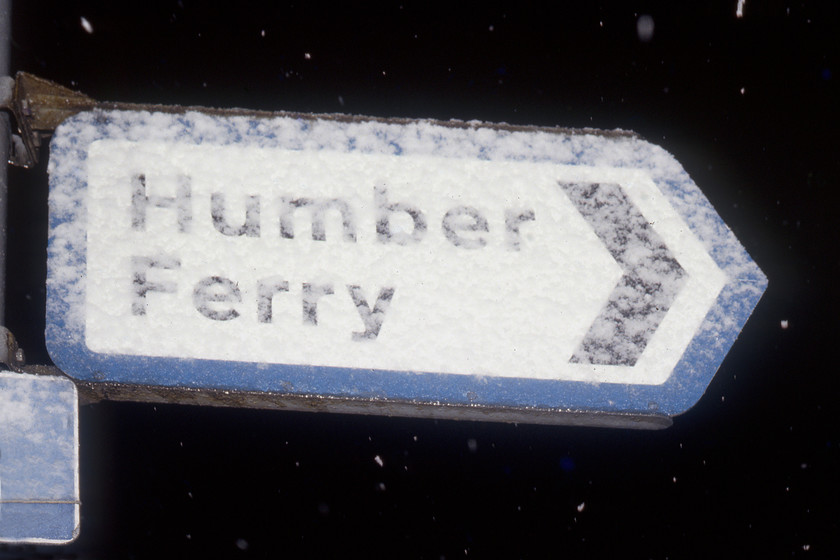 Humber Ferry road sign, Hull Corporation Pier 
 With the sign pointing towards the Humber Ferry becoming obscured by snow now falling thick and fast we were in for an interesting drive across the Yorkshire Wolds to York. Indeed, the journey along the A1079 was tricky with a lot of slipping and sliding in the Austin 1100 shorn with its next to useless re-mould tyres. We were relieved to reach Market Weighton finding the glow of a chip shop in Market Place a very welcome sight! 
 Keywords: Humber Ferry road sign Hull Corporation Pier