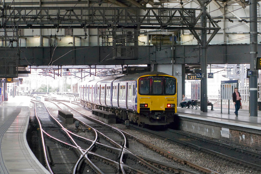 150140, NT 12.26 Leeds-Manchester Victoria (2U30), Leeds station 
 Northern Rail's 150140 and another unidentified unit will soon wor the 12.26 to manchester Victoria. It stands inside Leeds station that, despite being completely rebuilt relatively recently will win nothing in the design stakes. It is to undergo a further refurbishment and expansion in the coming few years and then there is HS3 off course! 
 Keywords: 150140 12.26 Leeds-Manchester Victoria 2U30 Leeds station Northern Rail Sprinter