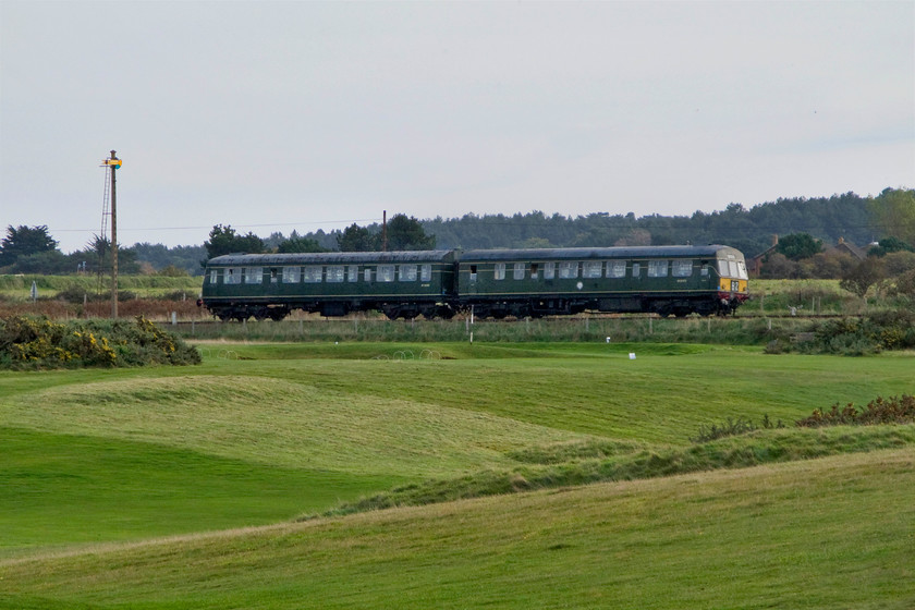 M51192 & M56352, 12.45 Sheringham-Holt, Sheringham Golf Club 
 With the manicured greens of Sheringham Golf Club in the foreground, M51192 leads M56352 working the 12.45 Sheringham to Holt train. Notice the Sheringham fixed distant signal to the left on its slotted concrete post. 
 Keywords: M51192 M56352 12.45 Sheringham-Holt Sheringham Golf Club class 101 DMU