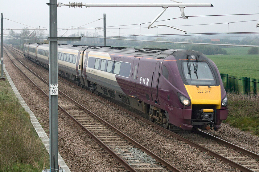 222014, EM 06.52 Nottingham-London St. Pancras (1B14, 6E), Wymington SP956634 
 Taken from the relatively new footbridge that was installed prior to the first phase of electrification near the village of Wymington EMR Merdian 222014 is seen. Along with much of EMR's stock, it is now wearing the rather garish purple 'house' livery and is seen heading south on the climb towards Sharnbrook summit near the village of Souldrop working the 1B14 06.52 Nottingham to St. Pancras train. 
 Keywords: 222014 06.52 Nottingham-London St. Pancras 1B14 Wymington SP956634 EMR East Midlands Railway Meridian