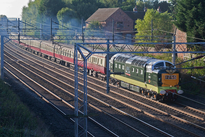 55022, outward leg of The Deltic Delight, 07.55 Wolverhampton-Newcastle (1Z55, 1L), Little Bridgeford 
 Looking absolutely superb in its reproduction green livery with a blood and custard set of ETH Mk. 1s (apart from the first coach of the consist) 55022 'Royal Scots Grey' makes fairly leisurely progress along the down slow line at Little Bridgeford. The Deltic is leading the outward leg of the 07.55 Wolverhampton to Newcastle charter that was routed via the WCML to Carlise where it would take the little-used single-track spur via London Road Junction that would permit it to continue along the Tyne Valley to its destination. Notice that the Deltic is running on one engine that was and is pretty common practice and not necessarily a cause for concern after all 47805/D1935 'Roger Hosking MA 1925-2013' was available for additional power if needed on the rear. 
 Keywords: 55022 The Deltic Delight 07.55 Wolverhampton-Newcastle 1Z55 Little Bridgeford Royal Scots Grey