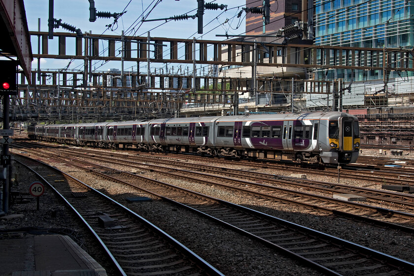 387137 & 387138, HX 12.42 Heathrow T4-London Paddington (1V52, 3L), London Paddington station 
 I was grateful for the shade offered by the buildings at the end of platform one of Paddington station on this hot summer's day! From this vantage point, 387137 leads 387138 pass through the station throat arriving with the 12.42 1V52 ex Heathrow Terminal Four service. The fares on these Heathrow Express services remain some of the most expensive in the country persistently ripping off passengers and visitors to the UK charging nearly a pound a mile for the journey from Heathrow. Yes, they advertise fares starting from 5.50 and advise people to book ahead but in all likelihood what foreign visiting travellers will be able to do that; welcome to rip-off Britain! 
 Keywords: 387137 387138 12.42 Heathrow T4-London Paddington 1V52 London Paddington station