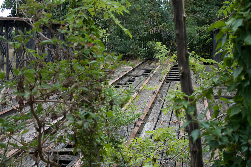 Former GN & GE River Welland bridge, Spalding 
 Whilst the railway heritage of the bridge over the River Welland in Spalding is clear to see I suspect that to locals who cross on the pedestrian section of the bridge don't even give a second thought. The tracks sat between steel sections seen here with level crossing gates at either end of the bridge. A photograph on Flikr is taken from an almost identical position and angle to the one I took here, see... https://www.flickr.com/photos/28083135@N06/49009212021 It is sobering to think that, apart from breakdown trains, the last train to rattle across this bridge was an empty sand train to Middleton Towers hauled by 37167 on the afternoon of Saturday 27th November 1982 closing the curtain on the GN and GE Joint line. 
 Keywords: Former GN & GE River Welland bridge Spalding