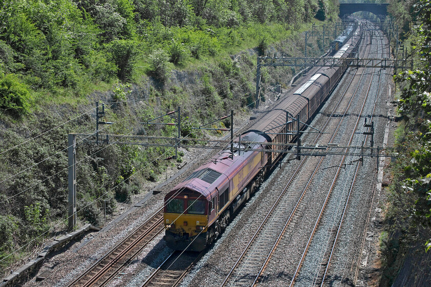 66221, 06.37 Dollands Moor-DIRFT (6M45, RT), Roade cutting 
 Back to its more normal length the 6M45 'bottled water train' passes through Roade cutting led, on this Saturday afternoon, by former EWS liveried 66221. This was one of my very first Class 66s photographed back in 2000 passing through Pitlochry on a southbound Freightliner. 
 Keywords: 66221 06.37 Dollands Moor-DIRFT 6M45 Roade cutting EWS