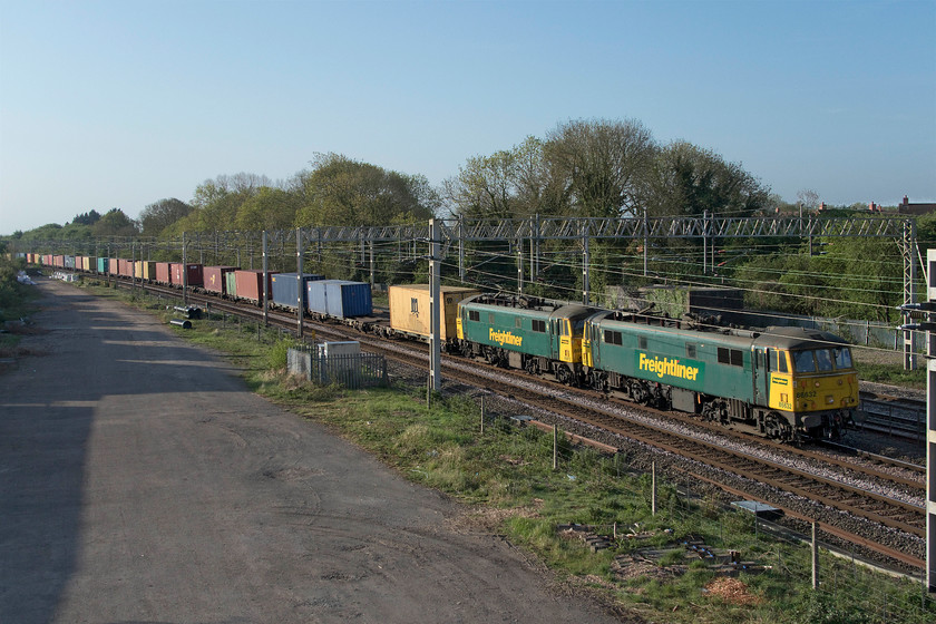 86632 & 86612, 02.50 Felixstowe North-Garston (4M45, 55E), site of Roade station 
 With a combined age of one hundred and ten years, AL6s 86632 and 86612 lead the 4M45 02.50 Felixstowe to Ditton Freightliner. The train is seen passing the site of Roade station on yet another superb spring morning that became a feature of the country's COVID-19 lockdown period. 
 Keywords: 86632 86612 02.50 Felixstowe North-Garston 4M45 site of Roade station Freightliner