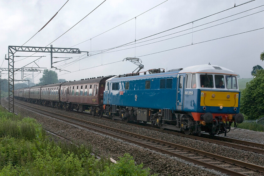 86259, outward leg of The Cumbrian Coast Express, 07.10 London Euston-Carlisle (1Z86), Milton crossing 
 Running bang on time running on a tight path between northbound Pendolinos, 86259 'LesRoss/Peter Pan' leads the outbound Cumbrian Coast Express past Milton crossing between Roade and Blisworth. Running as 1Z86 the AL6 left Euston at 07.10 heading for Carnforth where, on this occasion, LMS 8F 48151 took the train forward to Carlisle and then after a reversal around the superb Cumbrian coast line. 
 Keywords: 86259 The Cumbrian Coast Express 07.10 London Euston-Carlisle 1Z86 Milton crossing Les Ross Peter Pan AL6