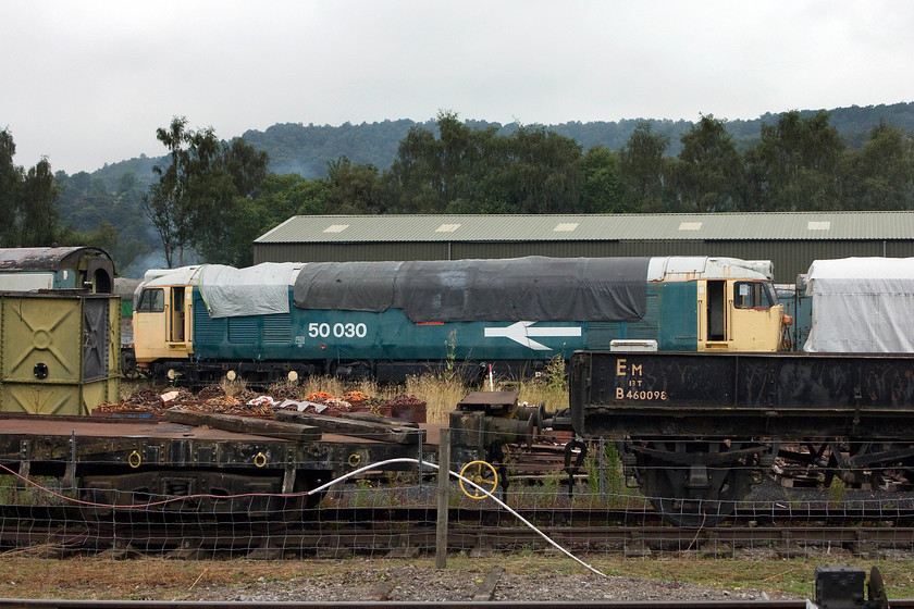 50030, stabled, Rowsley South 
 With rather faded large-logo paintwork but protected from the worst of the element by tarpaulins, 50030 'Repulse' awaits further work at its Peak Rail base. It is owned by the Renown Repulse Restoration Society and, until fairly recently, was operational. 
 Keywords: 50030 Rowsley South