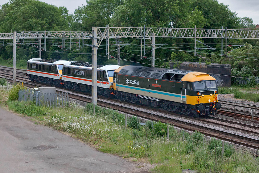 47712, 90001 & 90002, 15.56 Eastleigh Arlington-Crewe HS (0Z37, 12E), site of Roade station 
 A photograph that could have been taken in the early 1990s perhaps? It shows 47712 'Lady Diana Spencer' towing former GA 90001 and 90002 as the 15.56 Eastleigh Arlington to Crewe HS running as 0Z37 passing Roade. The two Class 90s look absolutely superb in their shiny new Intercity Swallow livery complete with cast birds attached to the side of the locomotives. There was considerable debate on the internet about whether this is an authentic livery for this class. To be honest, I don't care too much as I think its suits them well and hope that I will see them hauling trains again run by Locomotive Services Limited (LSL) from their Crewe base. Incidentally, I saw and photographed 90001 when it was leaving its former operator making its way to LSL back in April, see...... https://www.ontheupfast.com/p/21936chg/28968884604/x90001-82127-82118-08-42-norwich ; I wonder what has happened to the nameplates? 
 Keywords: 47712 90001 90002 15.56 Eastleigh Arlington-Crewe HS 0Z37 site of Roade station Lady Diana Spencer Intercity swallow