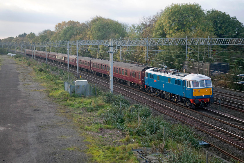 86259, outward leg of The Cumbrian Mountain Express, 07.10 London Euston-Carlisle (1Z86), site of Roade station 
 It's a good job that I did not decide to go and see the 1Z86 Cumbrian Mountain Express somewhere on the Weedon Loop on this morning as I would have been waiting a long time! For some reason it has been pathed on the down slow and will go via Northampton. 86259 'Les Ross/Peter Pan' leads the regular special past the site of Roade station. The re-routing of the train did not cause any long term issues as it still arrived within a minute of its booked time at Farington Junction. 
 Keywords: 86259 The Cumbrian Mountain Express 07.10 London Euston-Carlisle 1Z86 site of Roade station