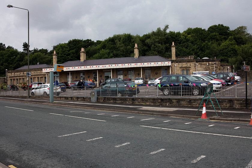 Frontage, Buxton station 
 The frontage of Buxton station with the inevitable car park in the foreground. This is the one remaining station of the two that were virtually identical design built side by side at this location. This one was operated by the LNWR for services to the Manchester area. The other one was operated by the Midland for services south and over the more challenging routes through the Peak District that closed in 1967. 
 Keywords: Buxton station