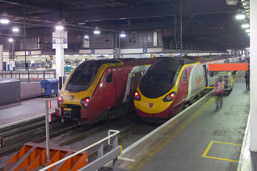 221118, VT 19.10 London Euston-Holyhead (1D93, 9L) & 390132, VT 19.23 London Euston-Wolverhampton (9G41, 5L), London Euston station 
 Two Virgin services wait to leave London Euston. To the left is 221118 that will work the 19.10 to Holyhead. To the right is 390132 'City of Birmingham' that will work the 19.23 to Wolverhampton. In this view, the brutalist and ugly nature of Euston station is clear........how will HS2 change its appearance? 
 Keywords: 221118 19.10 London Euston-Holyhead 1D93 390132 19.23 London Euston-Wolverhampton 9G41 London Euston station