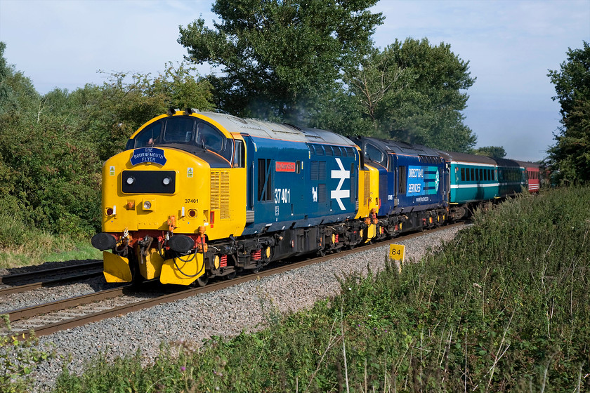 37401 & 37405, outward leg of The Bournemouth Flyer, 06.17 Chester-Bournemouth (1Z37), King`s Sutton SP486377 
 37401 'Mary Queen of Scots' and 37405 make a fine sight as they approach King's Sutton leading the outward leg of The Bournemouth Flyer railtour that left Chester at 06.17. The tour was a joint effort organised by Virgin Trains, DRS and The Railway Magazine. I was hoping that the Class 37s would be working hard at this location and whilst I could hear them for some time leaving Banbury they had notched back a little by the time they reached me as the train was catching up the previous running Southampton Freightliner. The train trailed this freight all the way to Oxford arriving a little adrift as a result. 
 Keywords: 37401 37405 The Bournemouth Flyer, 06.17 Chester-Bournemouth 1Z37 KIng`s Sutton SP486377 Tractors Mary Queen of Scots