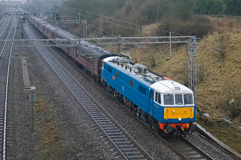 86259, outward leg of The Winter Cumbrian Mountain Express, 07.06 London Euston-Carlisle (1Z86), Victoria bridge 
 Looking particularly smart and sharp against the brown dullness of a late winter's morning 86259 'Les Ross/Peter Pan' heads north past Victoria bridge near the village of Roade leading the outward leg of The Winter Cumbrian Mountain Express charter from Euston to Carlisle. Thankfully and unlike last week, it was running to time as again I had personal commitments soon after the picture was taken, the charter was led by 60009 'Union of South Africa' on arrival into Carnforth. 
 Keywords: 86259 The Winter Cumbrian Mountain Express 07.06 London Euston-Carlisle 1Z86 Victoria bridge AL2 Les Ross Peter Pan