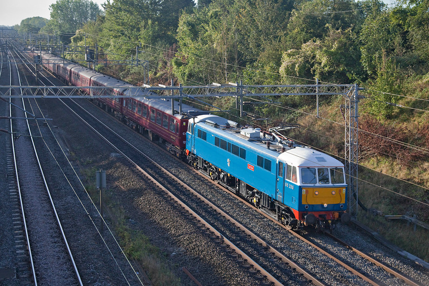 86259, outward leg of The Cumbrian Mountain Express, 07.10 London Euston-Carlisle (1Z86), Victoria bridge 
 As usual, 86259 'Les Ross/Peter Pan' looks absolutely superb, particularly in the early autumn sunshine. It is seen here on the WCML between Roade and Ashton working the outward Cumbrian Mountain Express from Euston to Carlisle with steam taking over at Carnforth. I have observed and photographed this train many times and am always somewhat surprised at the lack of passengers on this leg of the trip. I wonder where most get on as it heads northwards? 
 Keywords: 86259 The Cumbrian Mountain Express 07.10 London Euston-Carlisle 1Z86 Victoria bridge