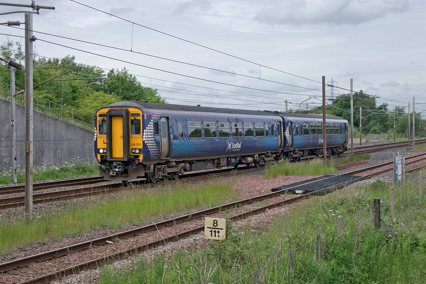 156413, SR 13.05 Dumfries-Carlisle (2L77, 1L), Mossband M6 bridge NY347654 
 Andy and I decided to stay for one final train at Mossband bridge between Carlisle and Gretna before moving on. I went to the northern side of the bridge, that was constructed in 2007/8 to carry the M6/M74 contiguous section of road linking Scotland with England over the border near Gretna. 156413 picks up speed after joining the WCML at Gretna Junction working the 13.05 Dumfries to Carlisle local service. The milepost indicates that this location is eight and three-quarter miles north from Carlisle heading towards Glasgow and Edinburgh via the LMS route. 
 Keywords: 156413 13.05 Dumfries-Carlisle (2L77, 1L), Mossband M6 bridge NY347654