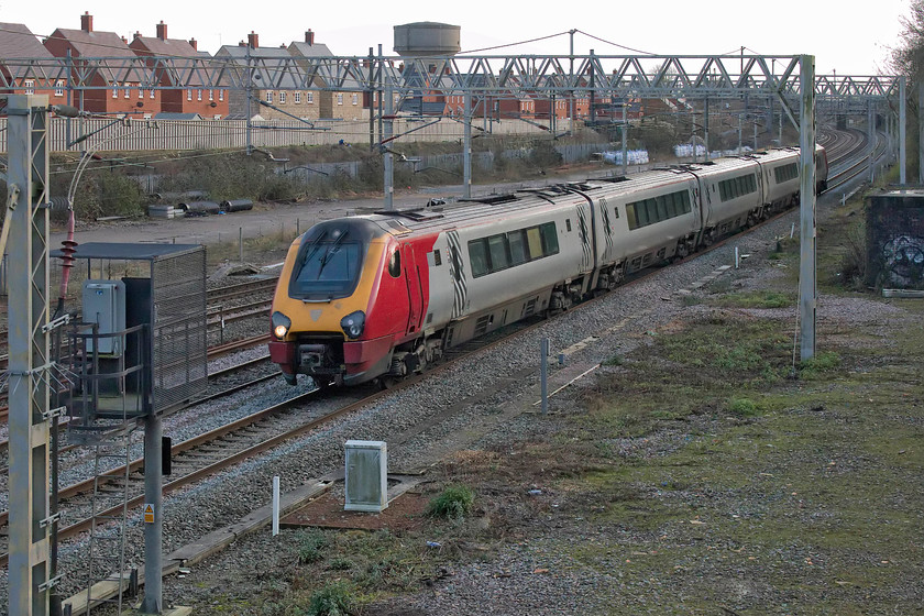 221110, VT 12.10 London Euston-Chester (1D86, 1E), site of Roade station 
 220110 'James Cook' passes the site of the former station at Roade with the 12.10 Euston to Chester service. Whilst this view is a little cluttered, until recent Network Rail clearance, any photograph from this spot was totally impossible due to rampant vegetation growth. The small relay building to the far right of the image marks the location of the fine LNWR signal box that was demolished when it became redundant in the mid-1960s. 
 Keywords: 221110 12.10 London Euston-Chester 1D86 site of Roade station