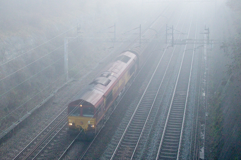 66079, 09.06 Dollands Moor-DIRFT (6C24, 13L), Roade cutting 
 66079 passes through Roade cutting leading the 6C24 Dollands Moor to Daventry bottled water train. With the SuO 4L48 Tesco Express not running at the moment, this freight and its balancing working south are the only regular Sunday freight workings in this area. 
 Keywords: 66079 09.06 Dollands Moor-DIRFT 6C24 Roade cutting