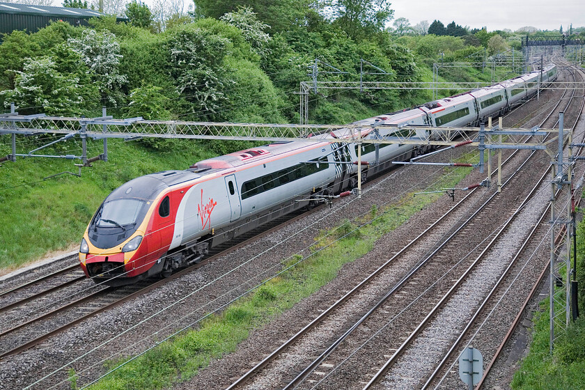 390050, VT 05.45 Wolverhampton-London Euston, Victoria bridge 
 The morning 05.45 Wolverhampton to Euston Virgin service passes Victoria bridge worked by 390050. The open coupling door at the front end of the Pendolino will be doing nothing for its aerodynamics! 
 Keywords: 390050 05.45 Wolverhampton-London Euston Victoria bridge 390050, VT 05.45 Wolverhampton-London Euston, Victoria bridge Virgin Pendolino