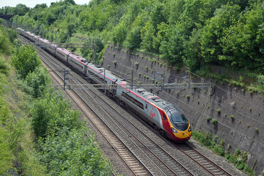 390124, VT 11.03 London Euston-Birmingham New Street (9G13, 16L), Roade Cutting 
 High summer in Roade Cutting! Almonst the lush greeery of the magnificant Roade Cutting 390124 'Virgin Venturer' works the 11.03 London Euston to Birmingham New Street. 
 Keywords: 390124 9G13 Roade Cutting