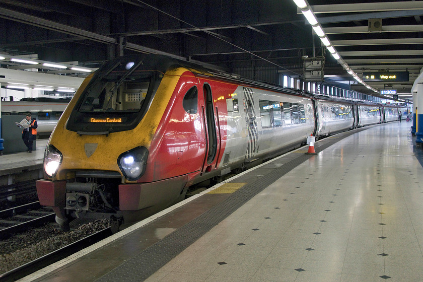 221109, VT 11.43 London Euston-Glasgow Central (9S65, 25L), London Euston station 
 Our train back from Euston to Milton Keynes waits at Euston's platform six. 222109, forming the 11.43 to Glasgow Central, appears to be ostensibly a Virgin train being in their familiar livery but devoid of branding. Avanti West Coast has been operating these units for some weeks now but have made no moves to put their stamp on them. With them to come off-lease soon I suspect that no work will be done to these Voyagers with them going to other operators. 
 Keywords: 221109 11.43 London Euston-Glasgow Central 9S65 London Euston station Voyager Avanti West Coast Virgin Trains