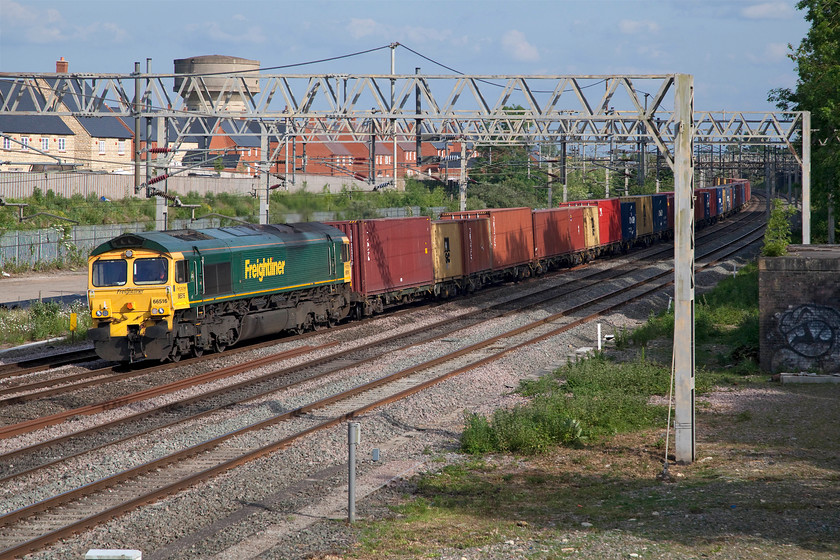 66516, 12.57 London Gateway-Garston (4M56, 33E), site of Roade station 
 Freight number 3 (17.50) -

66516 leads the fully loaded 4M56 12.57 London Gateway to Garston past Roade. With the failed train at Long Buckby now cleared traffic was being pushed through quickly to clear the backlog. This working completely missed its layover just north of Northampton arriving proportionately early at Garston later in the evening. 
 Keywords: 66516 12.57 London Gateway-Garston 4M56 site of Roade station Freightliner