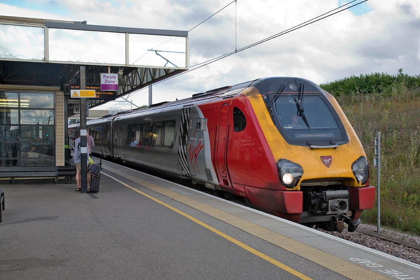 221107, VT 18.10 London Euston-Holyhead & Wrexham (1D92), Milton Keynes station 
 The 18.10 Euston to Holyhead Virgin service arrives at Milton Keynes Central being worked by 221107 'Sir Martin Frobisher'. The Voyager is named after the notable explorer who made three voyages to the New World searching for the fabled North-west Passage who is his later life was knighted for his efforts to help defeat the Spanish Armada in 1588. 
 Keywords: 221107 18.10 London Euston-Holyhead & Wrexham 1D92 Milton Keynes station Sir Martin Frobisher Virgin West Coast Voyager