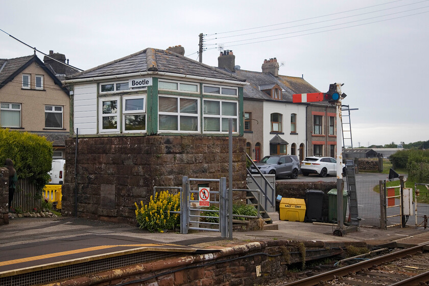 Bootle signal box (Furness, 1871) 
 Bootle signal box is seen at the northern end of the down platform. It is a Grade II listed structure 'as a rare surviving example of a Furness Railway Type 1 signal box, being the least altered example of the two survivors on the national rail network' according to the citation on the Historic England entry. Close examination of the photograph does reveal some rot to the timbers of the box so it appears that some timely maintenance by Network Rail is required. 
 Keywords: Bootle signal box Furness 1871