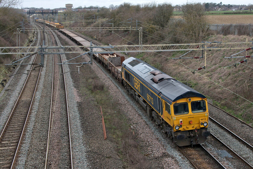 66713, 08.50 Alexandra Palace-Bescot Down sidings (9G63, RT), Victoria bridge 
 Dead in tow, 66713 'Forest City' sits at the rear of the 08.50 Alexandra Palace to Bescot engineering train as it passes Victoria bridge just a short distance south of Roade. The train is composed of a mixture of infrastructure wagons including MRA and YWA with single examples of an IEA, JNA, OCA and OBA. 
 Keywords: 66713 08.50 Alexandra Palace-Bescot Down sidings 9G63 Victoria bridge Forest City